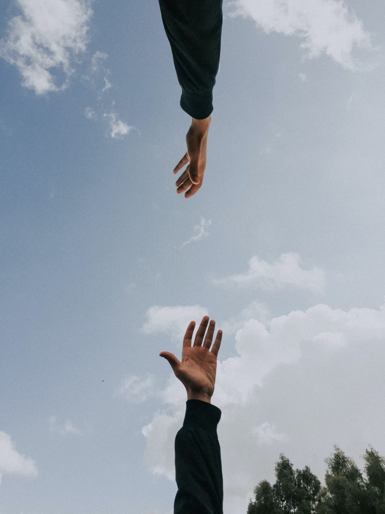 Two people reaching out to each other